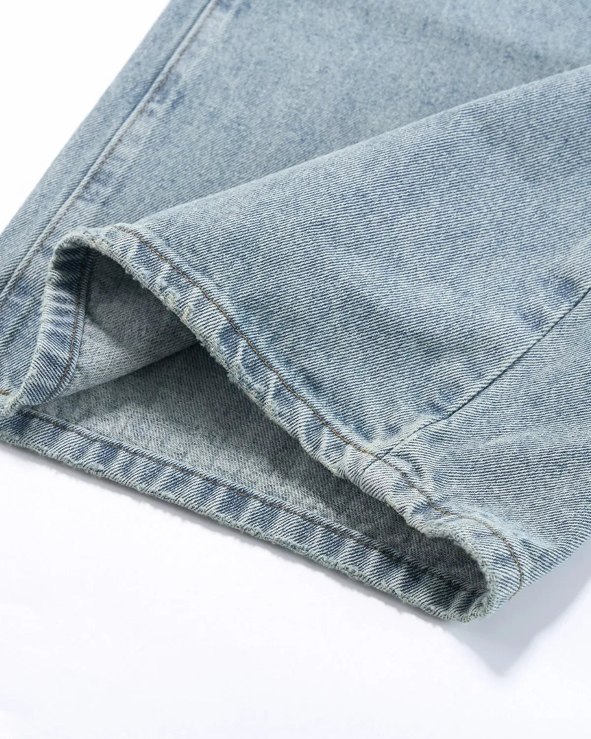 Blue vintage wash distressed baggy jeans by Flation, showcasing relaxed streetwear style with worn-in denim details.