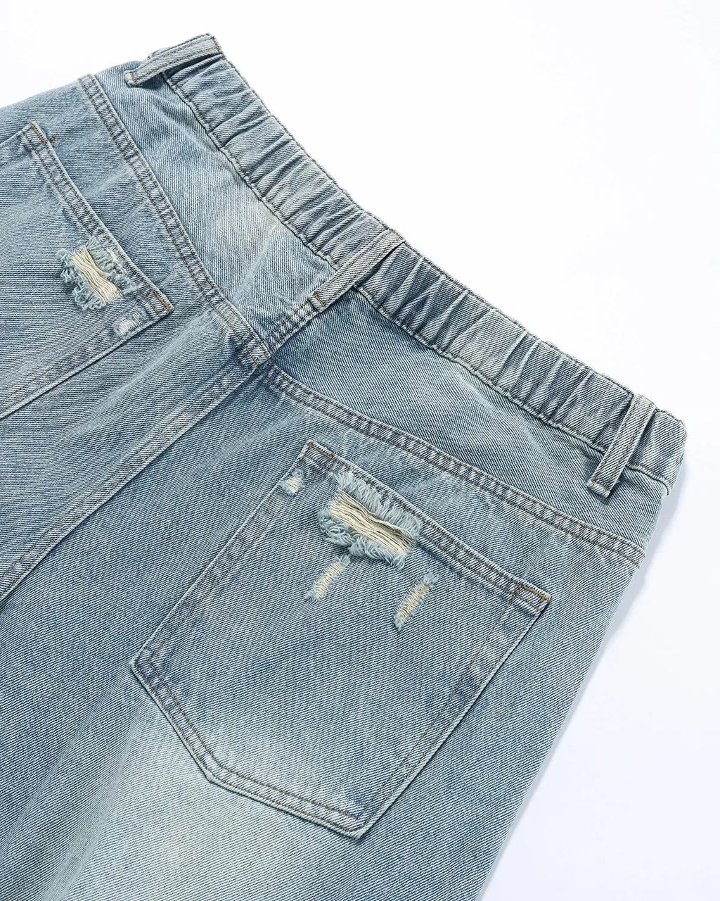 Blue vintage wash distressed baggy jeans by Flation streetwear, showing relaxed fit and faded denim details.