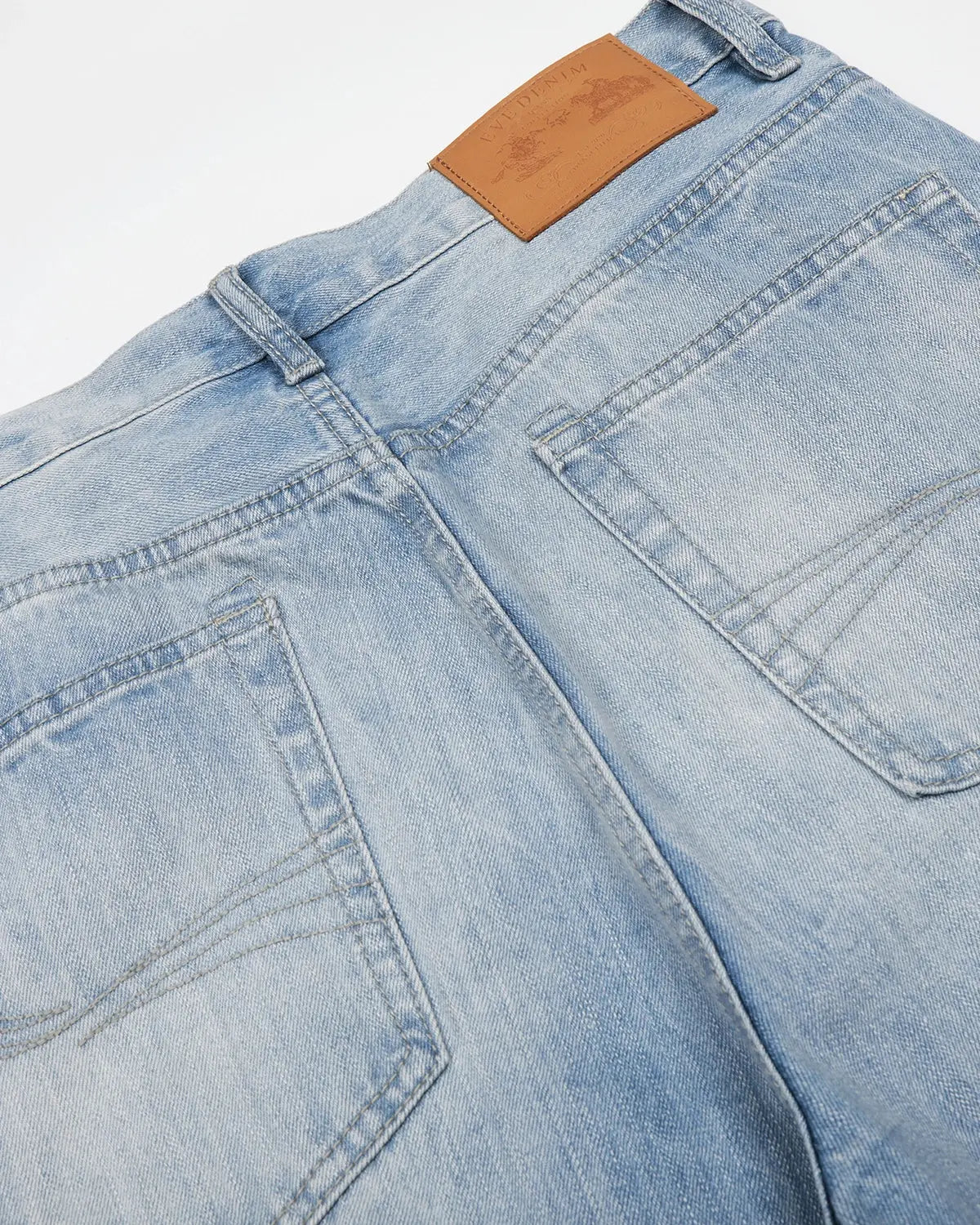 Blue vintage whiskered bootcut jeans by Flation Streetwear, shown with a relaxed fit and faded detailing.