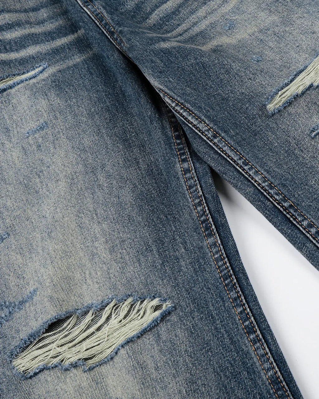 Blue Flation Whisker Wash distressed baggy jeans with a relaxed fit, featuring a faded, worn-in look and casual streetwear style.