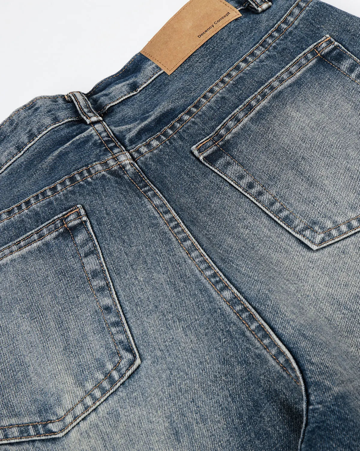 Blue distressed baggy jeans by Flation with whisker wash effect, streetwear style, shown on a model.