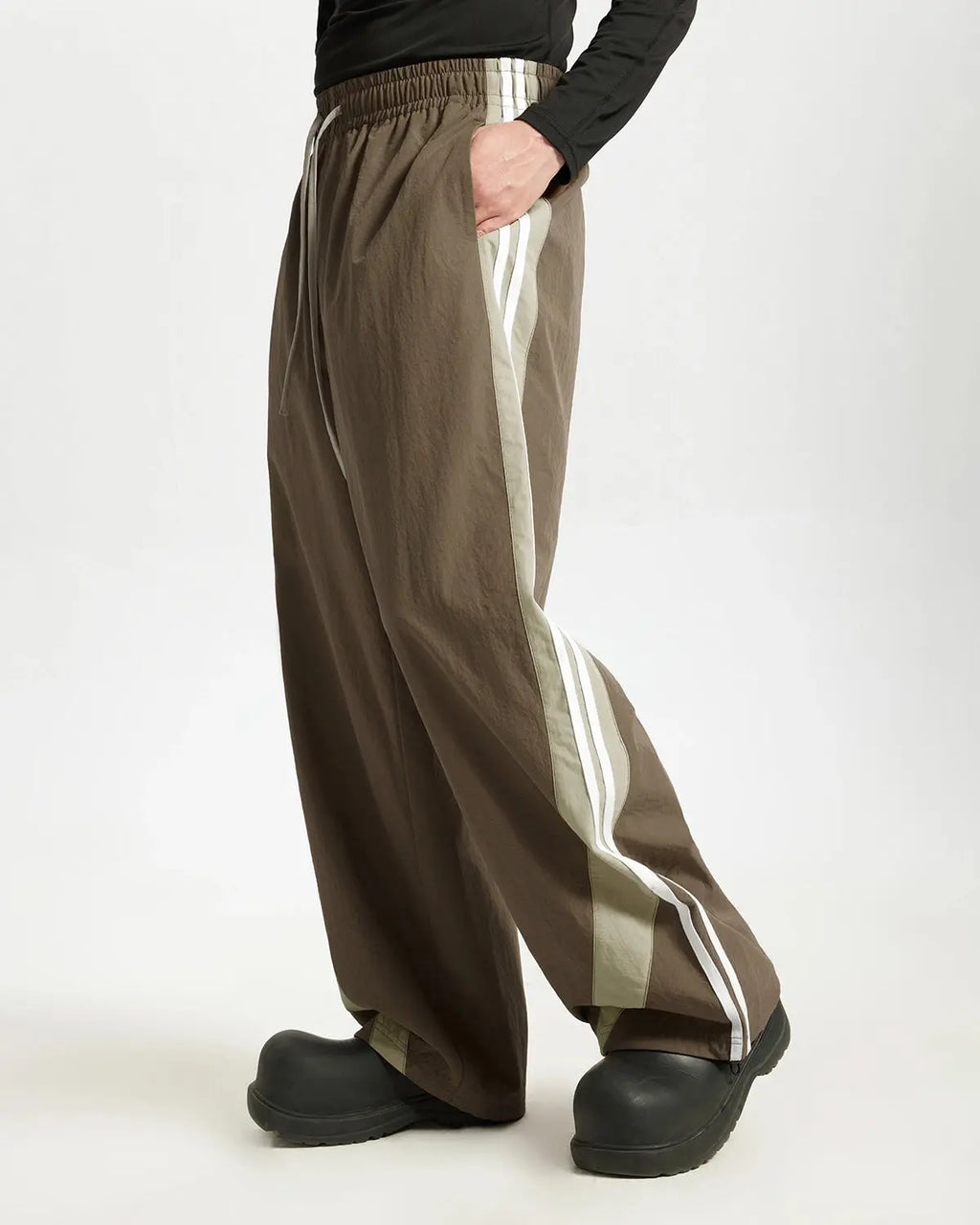 Brown striped casual pants by Flation Streetwear, featuring relaxed fit and stylish design for everyday wear.