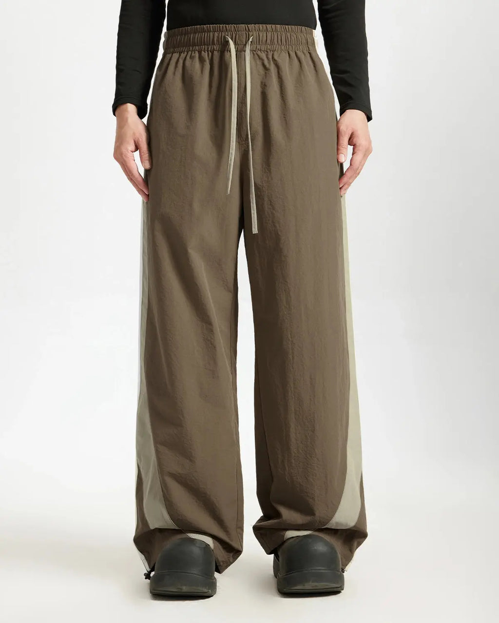 Brown striped casual pants by Flation Streetwear featuring relaxed fit and comfortable fabric for everyday wear.