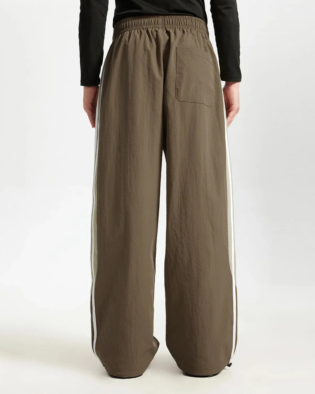 Brown striped casual pants by Flation Streetwear, featuring a relaxed fit and stylish pattern.