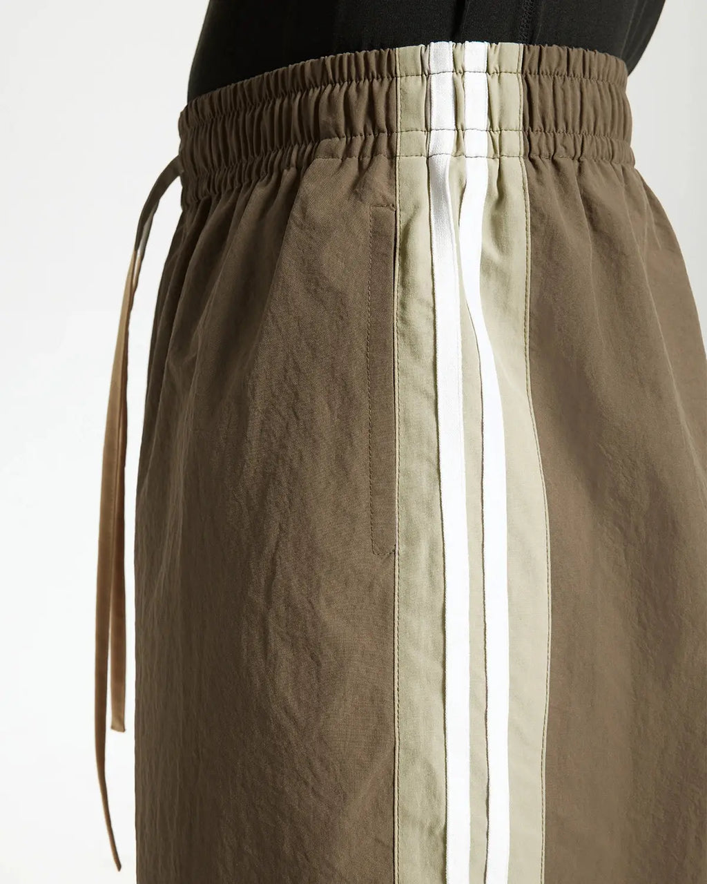 Brown striped casual pants by Flation Streetwear, featuring a relaxed fit and stylish striped pattern for everyday wear.