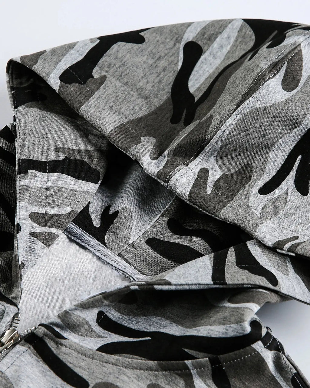 Cropped camouflage zip-up hoodie by Flation Streetwear with a hood and front zipper, featuring green and brown camo pattern.