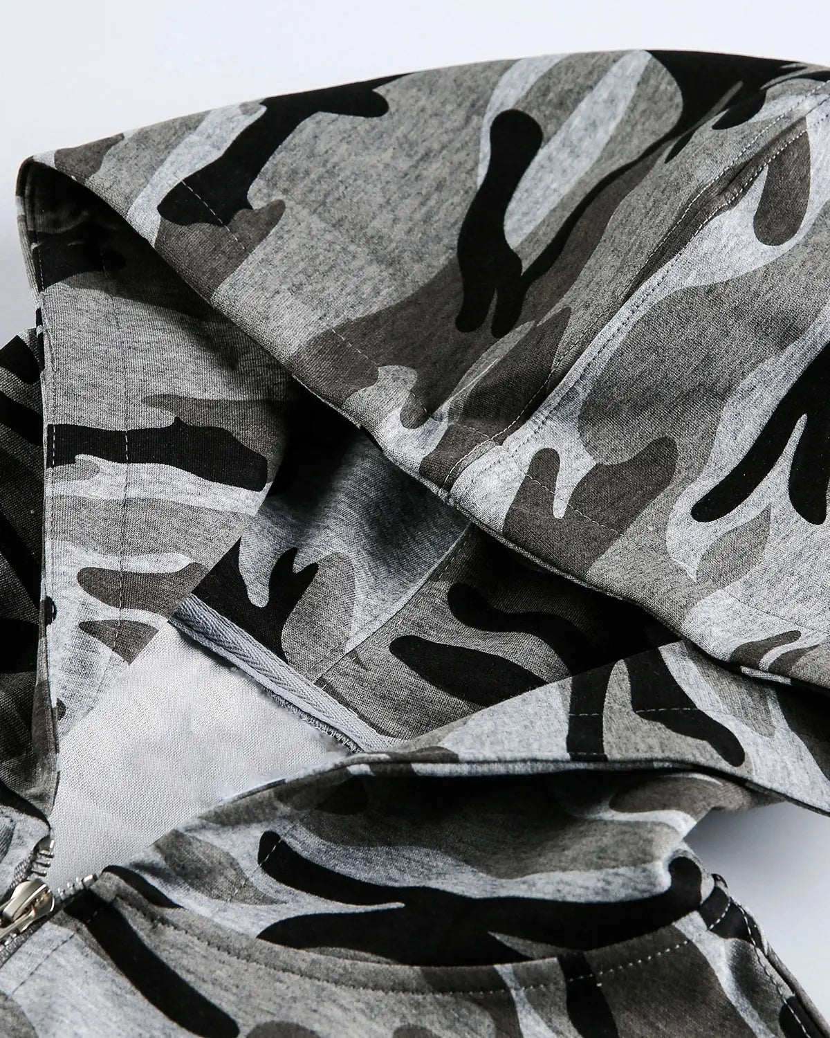 Cropped camouflage zip-up hoodie by Flation Streetwear with a hood and front zipper, featuring green and brown camo pattern.