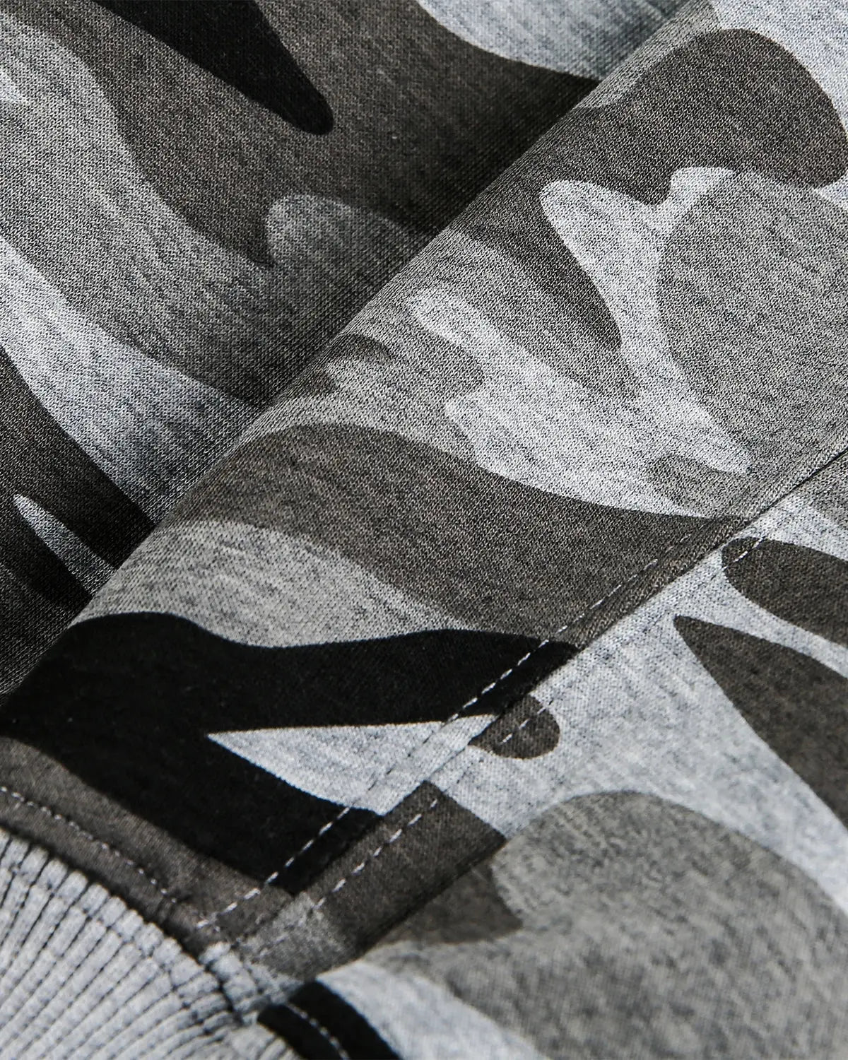 Cropped camouflage zip-up hoodie by Flation Streetwear featuring a green and black camo pattern and a front zipper.