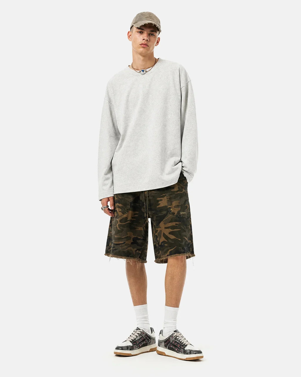 Flation camouflage knee-length shorts with frayed hem, casual streetwear style, featuring a rugged camo pattern and relaxed fit.
