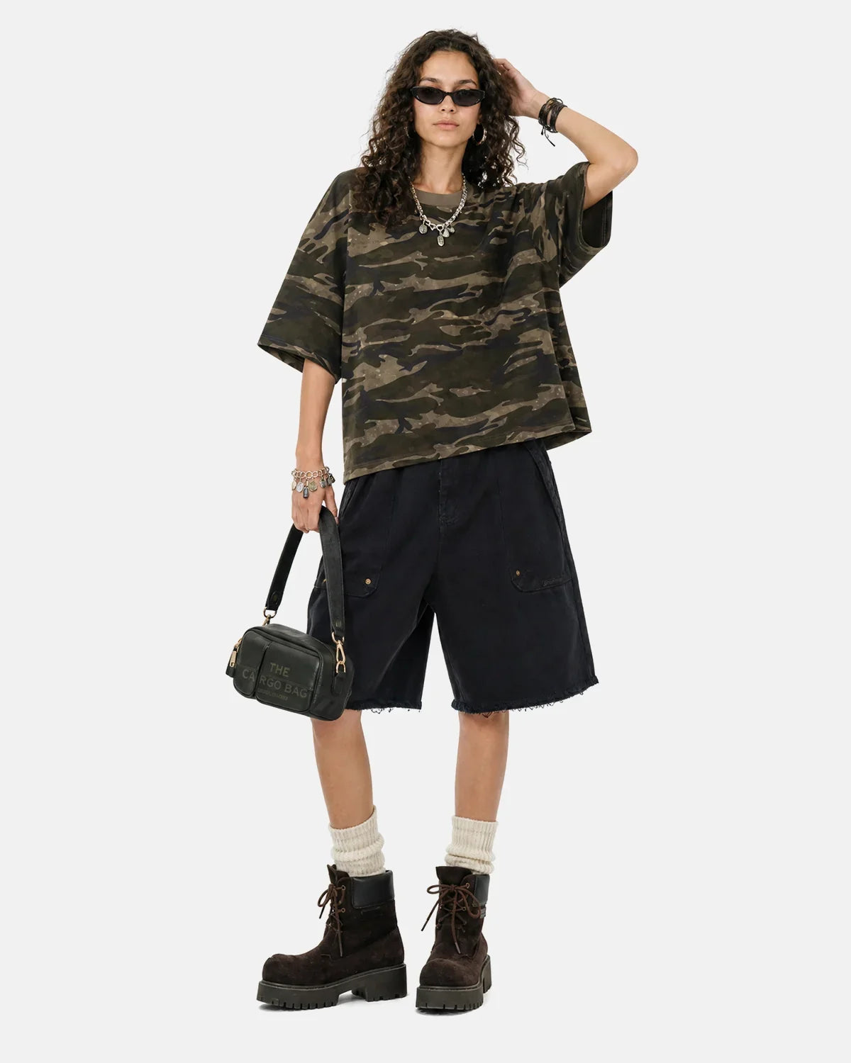 Flation camo knee-length shorts with frayed hem, casual streetwear style, featuring a green and beige camouflage pattern.