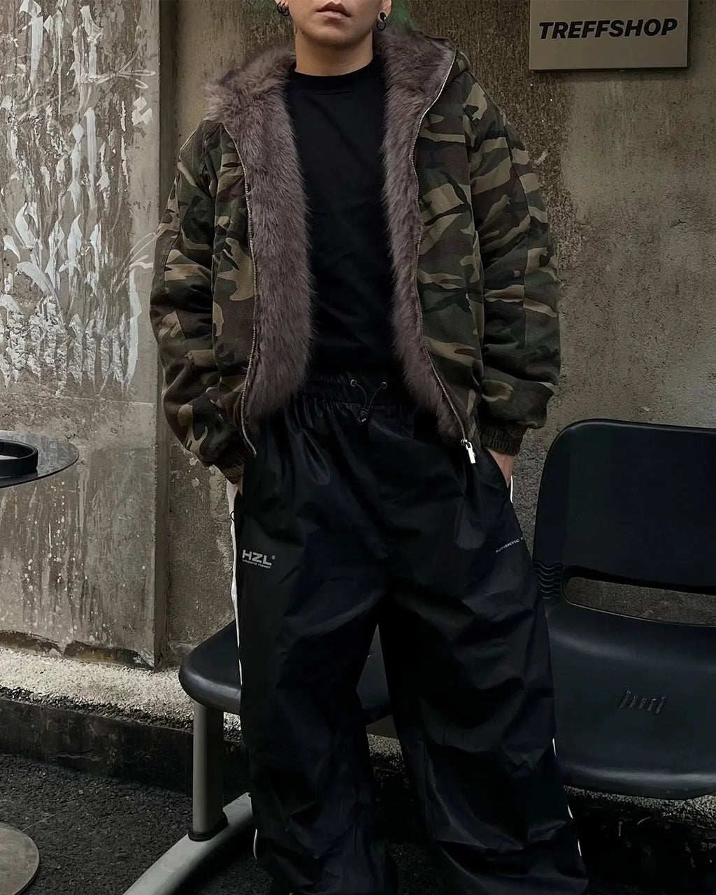 Camo faux fur-lined bomber jacket by Flation Streetwear with camouflage pattern and cozy fur interior, stylish and warm outerwear.