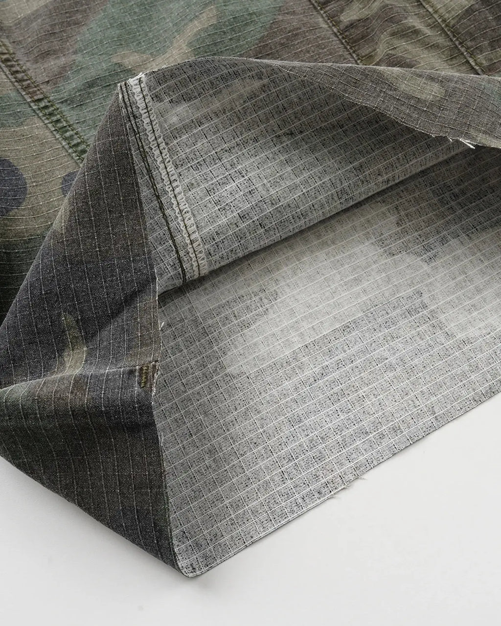 Camo utility longline shorts by Flation Streetwear featuring camouflage pattern, multiple pockets, and relaxed fit.