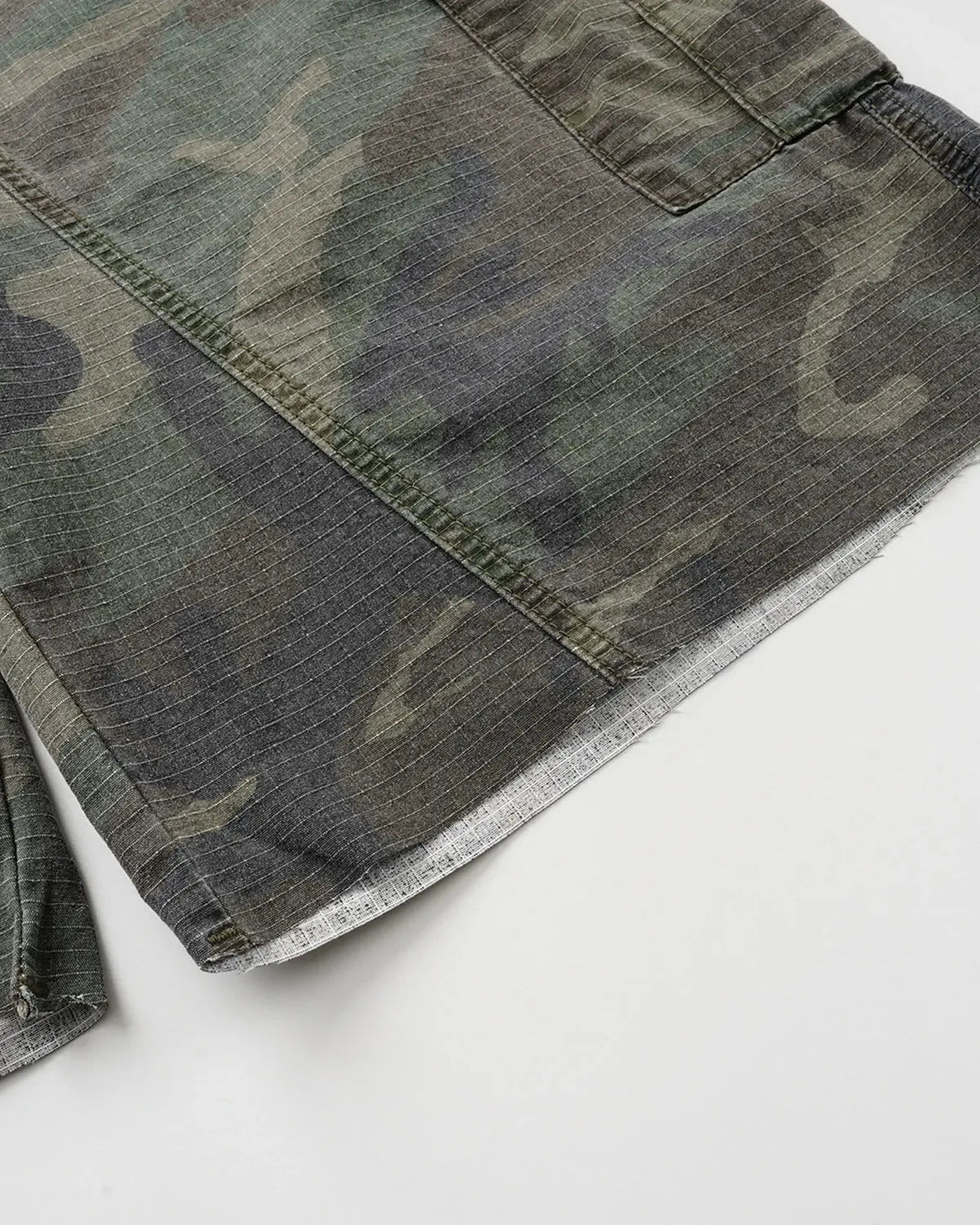 Camo utility longline shorts by Flation Streetwear featuring a camo pattern, multiple pockets, and a relaxed fit.