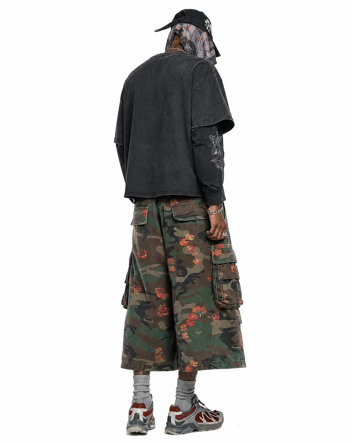 Flation floral camo cargo longline shorts featuring a mix of floral and camouflage patterns, with a relaxed streetwear style.