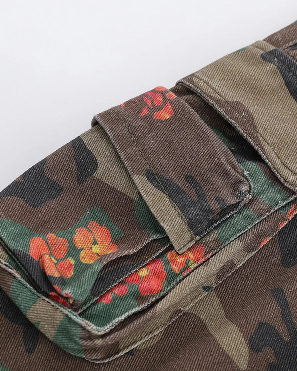 Flation floral camo cargo longline shorts featuring a mix of floral and camouflage patterns, streetwear style, and relaxed fit.