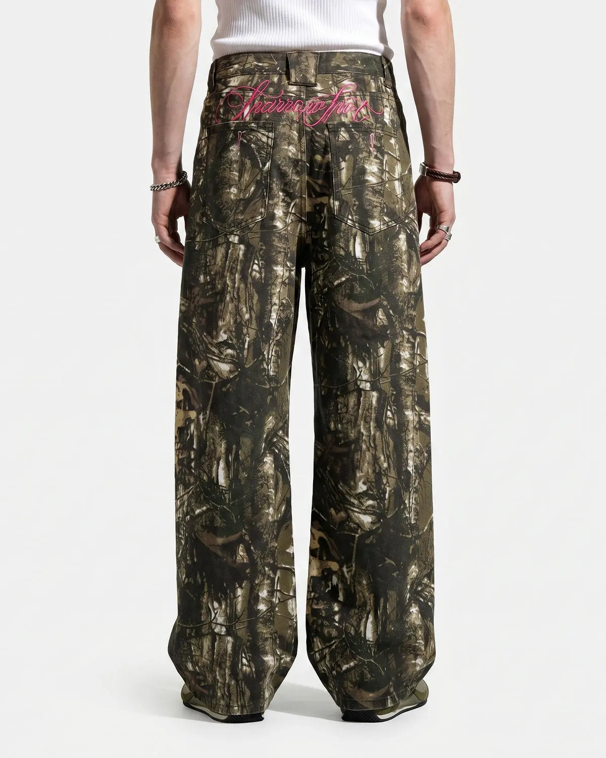Pink embroidered camo baggy pants from Flation Streetwear, showcasing relaxed fit and detailed embroidery on soft camo fabric.