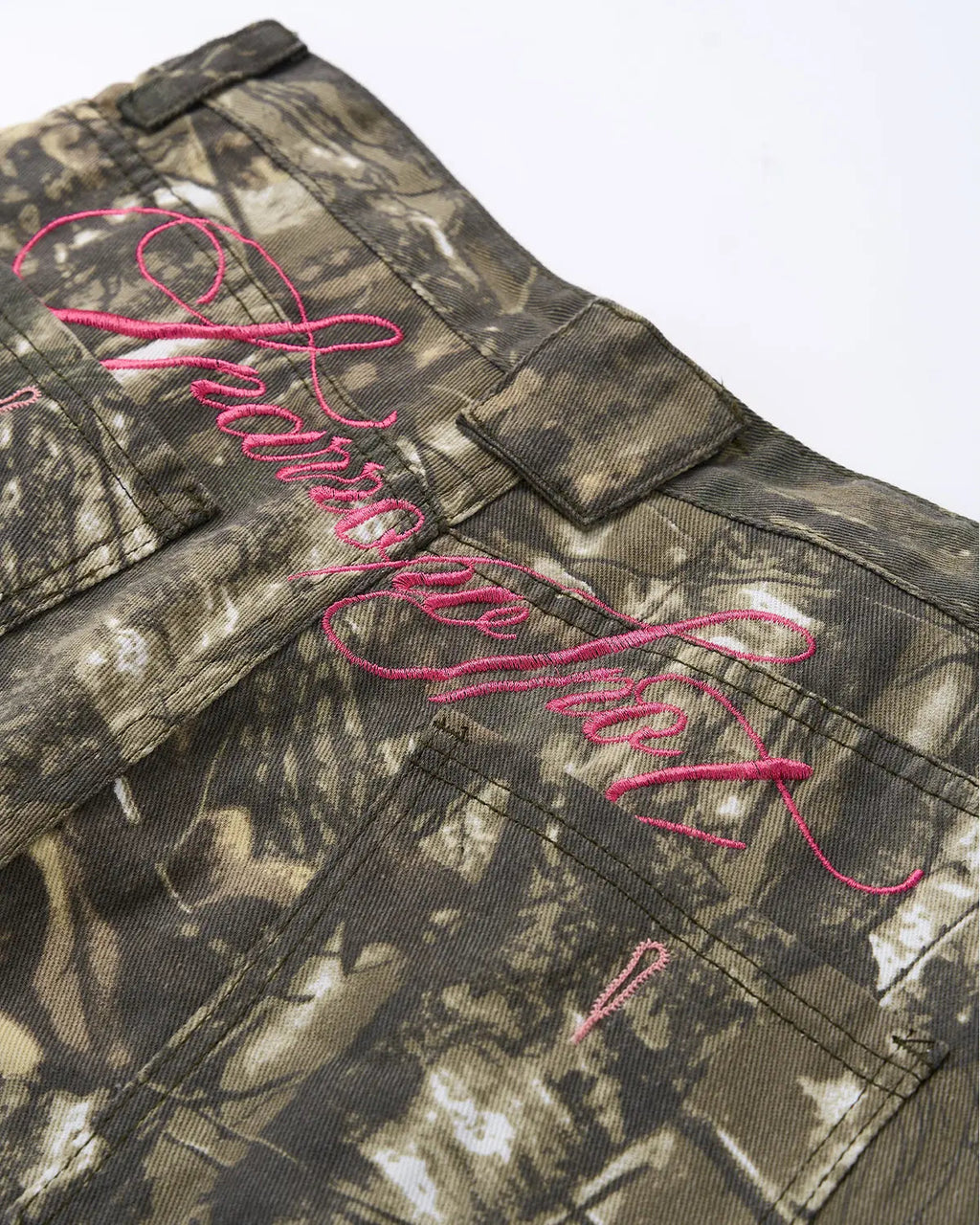 Pink embroidered camo baggy pants by Flation Streetwear, showcasing relaxed fit with detailed embroidery and casual street style.