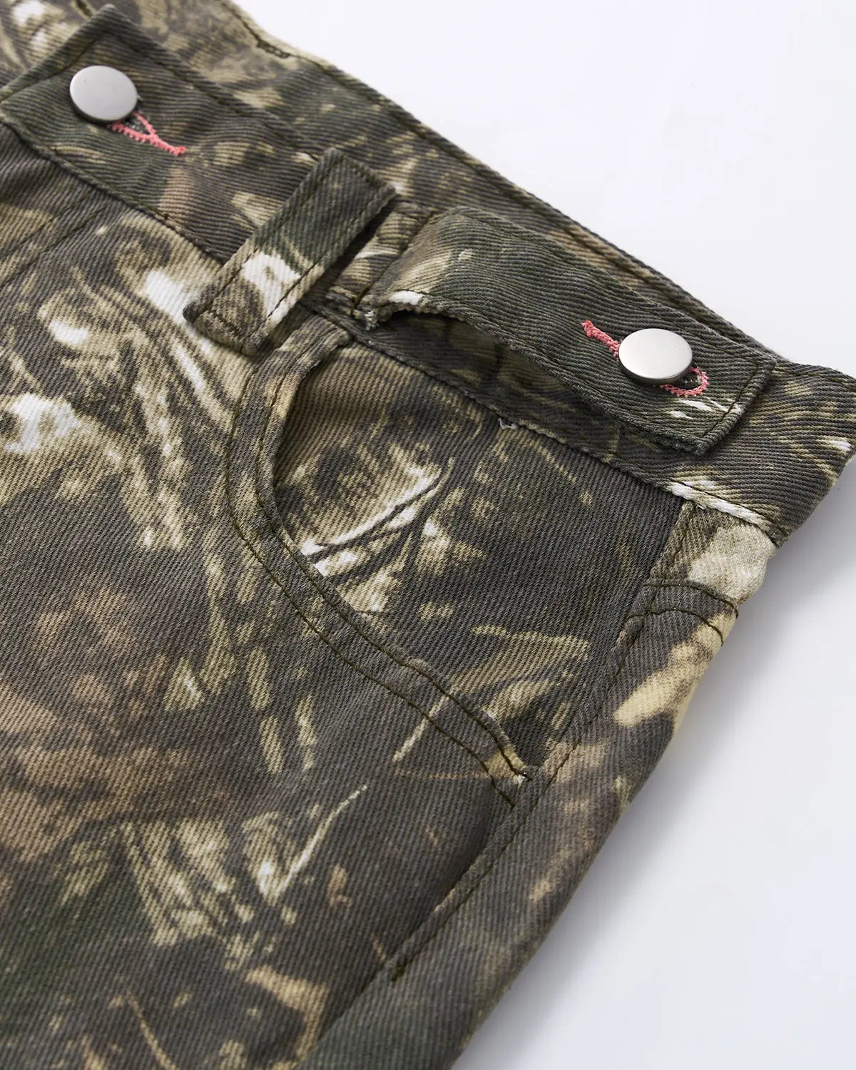 Pink embroidered camo baggy pants from Flation Streetwear with relaxed fit and detailed stitching, styled for casual street fashion.