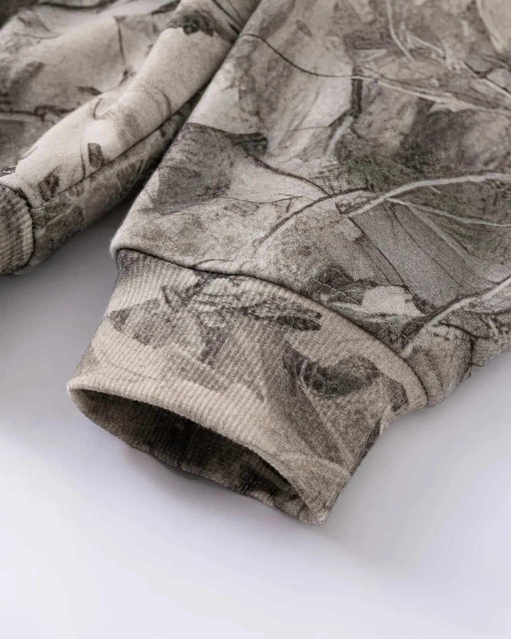Realtree camo zip-up hoodie by Flation Streetwear featuring a camouflage pattern, hood, and full-length zipper.