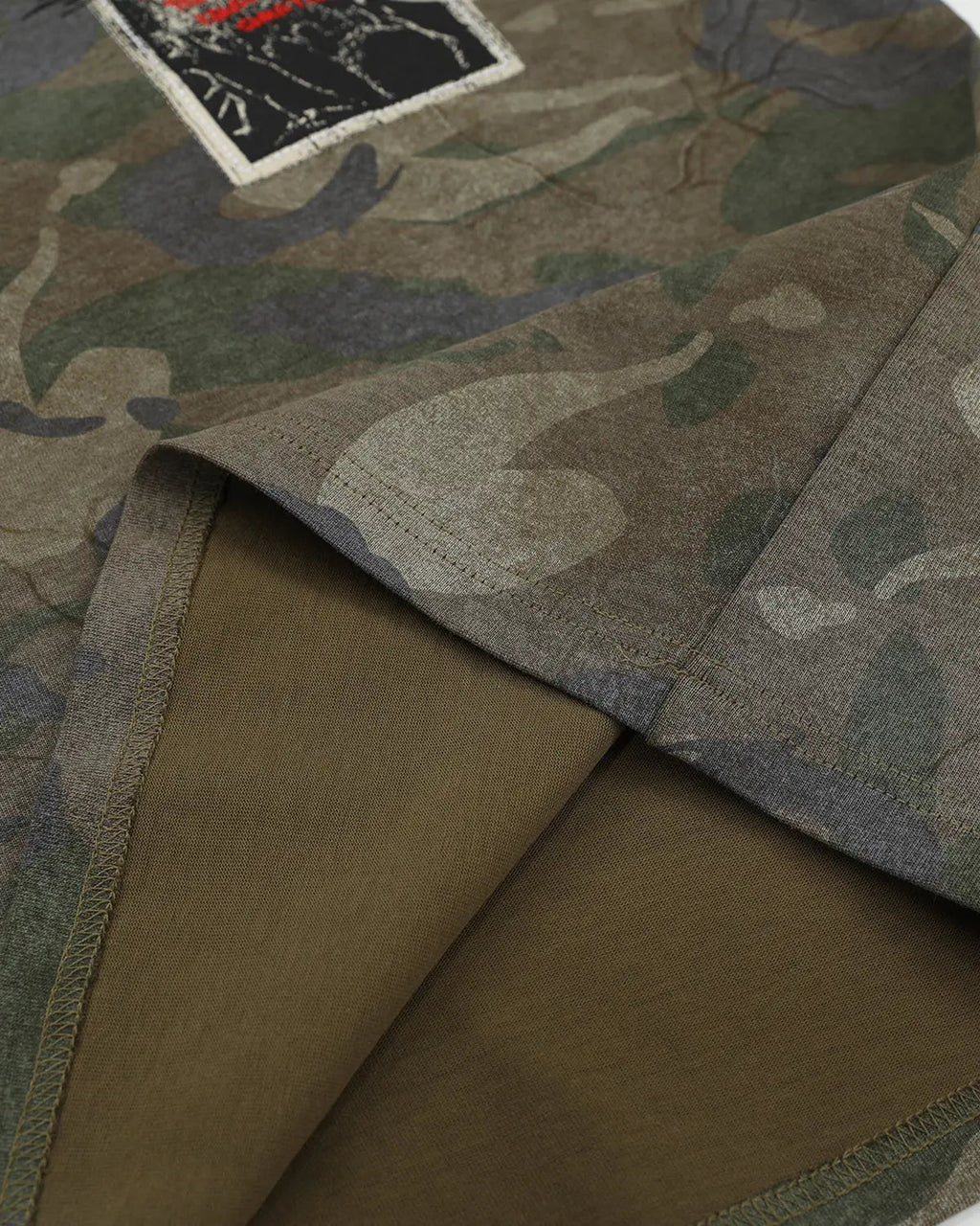 Vintage camo patch graphic T-shirt by Flation featuring military-inspired camouflage design and streetwear style.