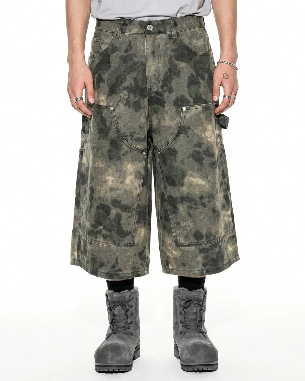 Washed camo cargo longline shorts from Flation streetwear displayed on a hanger against a neutral background.