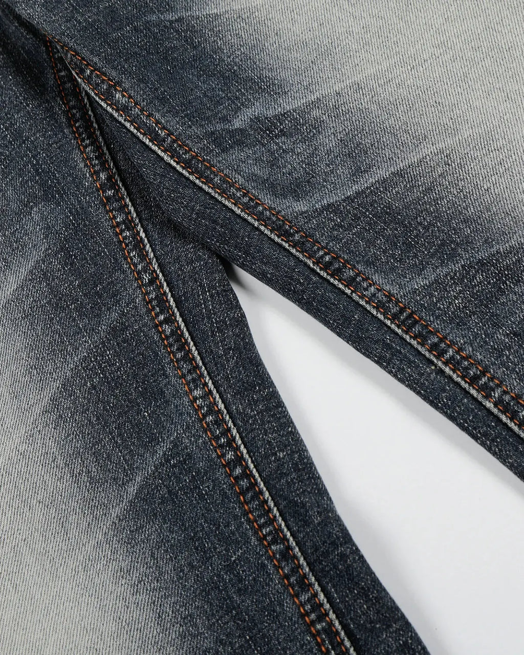 Faded Whisker Baggy Jeans by INFLATION featuring distressed denim, relaxed fit, and faded details, streetwear style.
