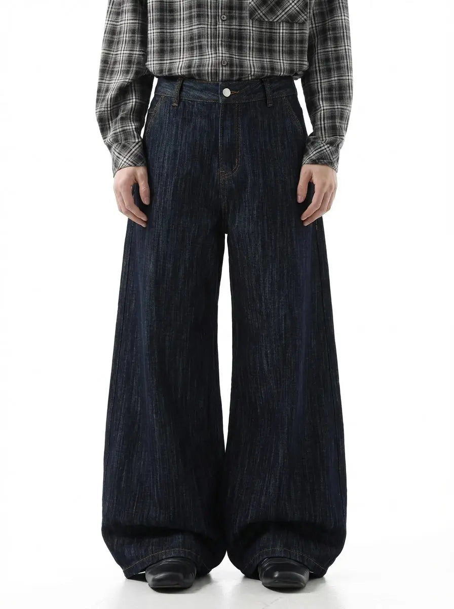 Dark indigo wide bootcut jeans by Flation Streetwear, showing the relaxed fit and classic denim style.
