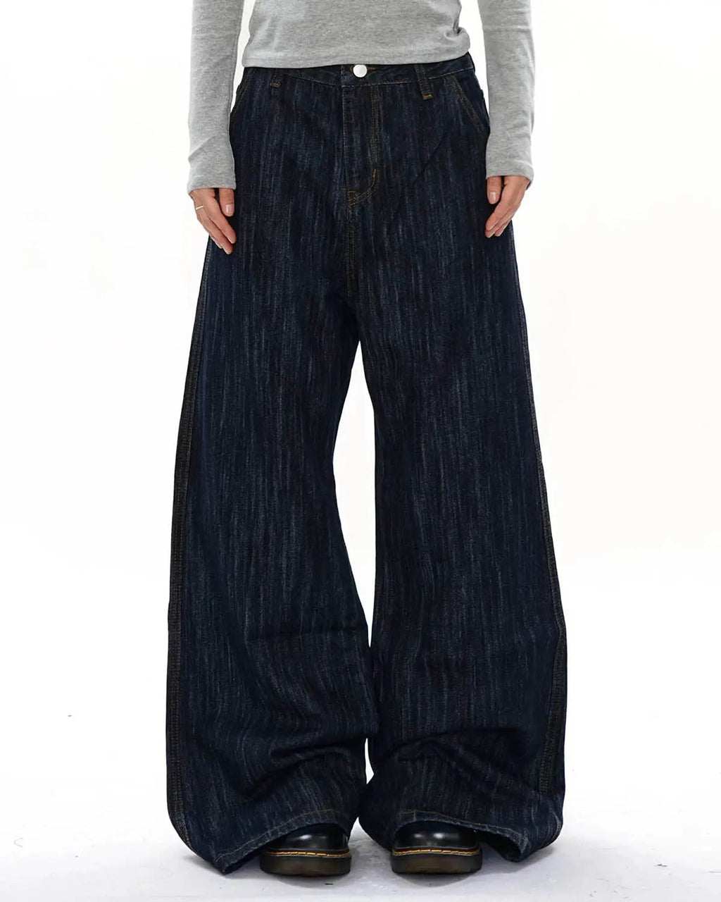 Dark indigo Flation Streetwear wide bootcut jeans shown on a model, featuring a relaxed fit and classic denim style.