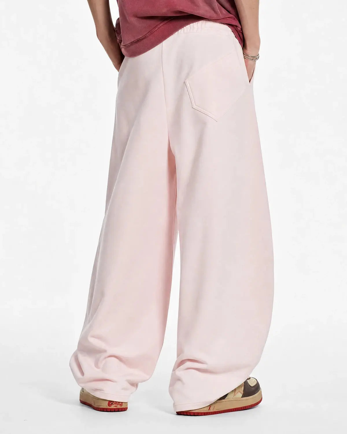 Gray Flation streetwear curved wide-leg sweatpants laid flat, showing their relaxed fit and soft fabric for comfortable casual wear.