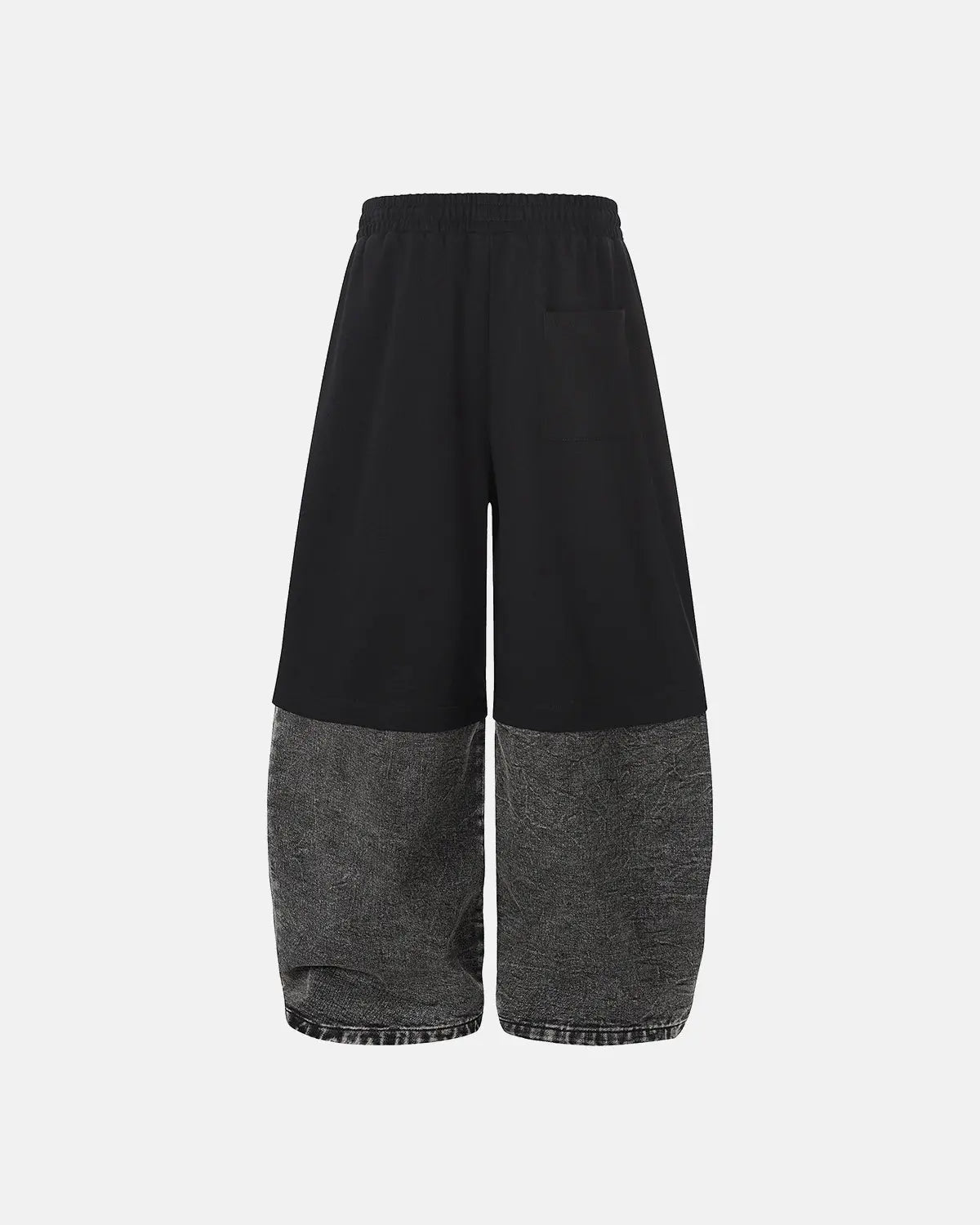 Gray denim Flation streetwear joggers with detachable patchwork details and barrel fit, featuring a casual, trendy design.