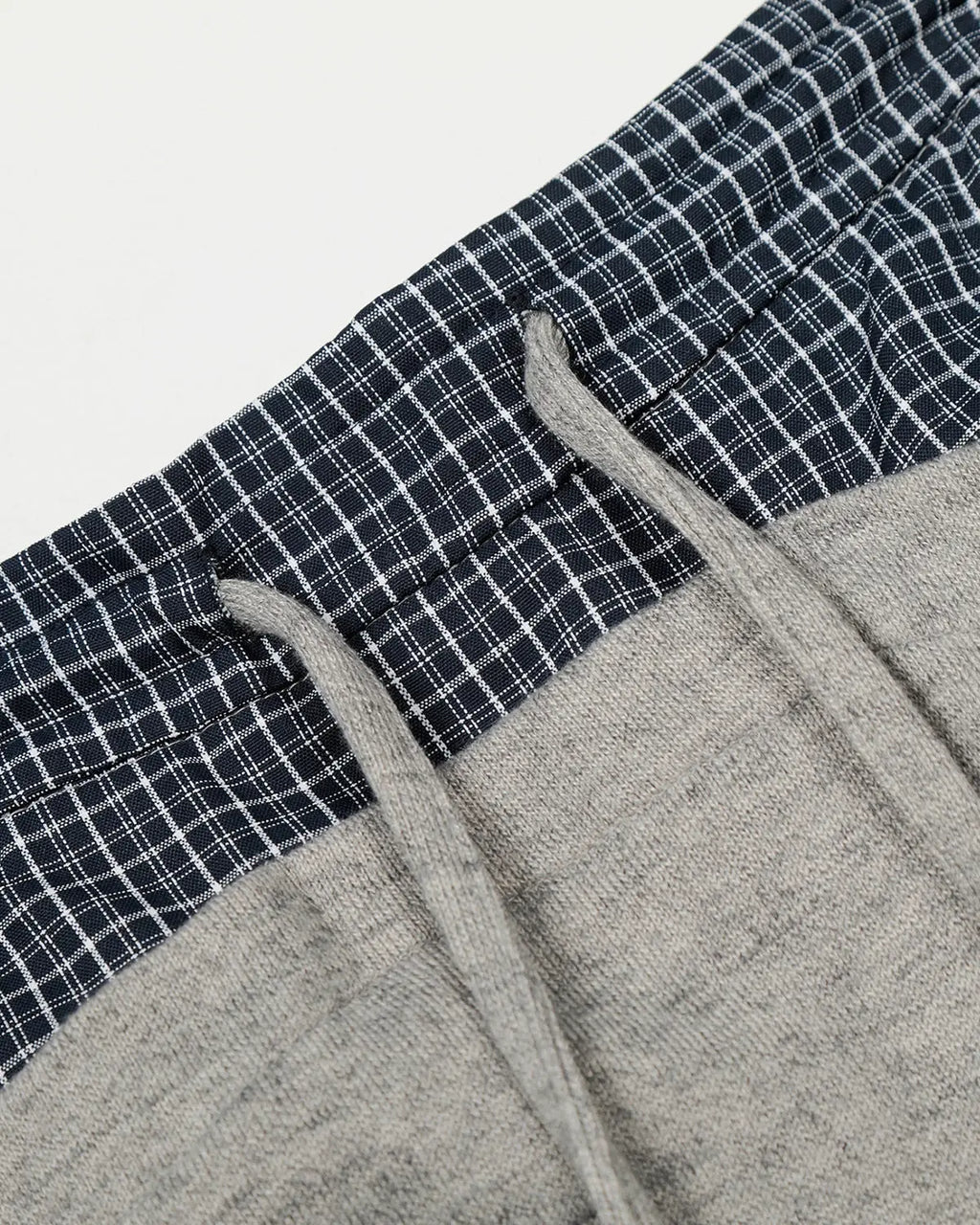 Plaid layered baggy sweatpants from INFLATION Streetwear featuring a relaxed fit and layered design with plaid pattern.