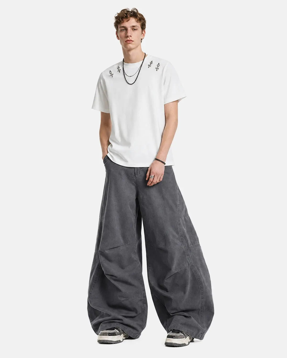 Gray washed curved seam cargo pants by Flation Streetwear, featuring relaxed fit and multiple utility pockets.