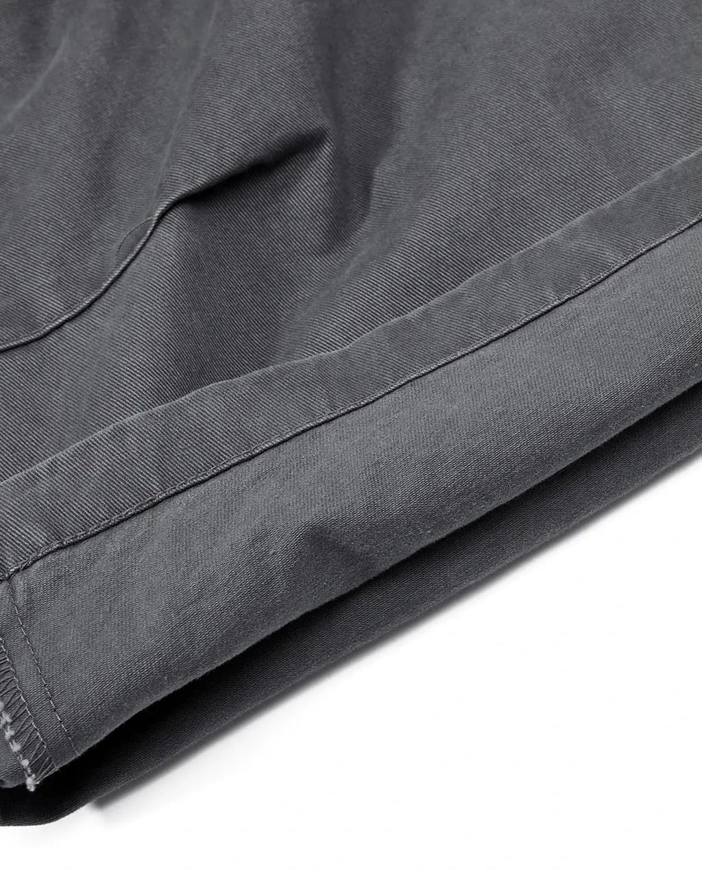 Gray washed curved seam cargo pants by Flation Streetwear, featuring relaxed fit and multiple utility pockets.