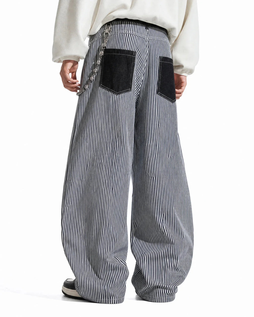Flation striped patch pocket baggy jeans with relaxed fit, featuring colorful striped patches and classic denim details.