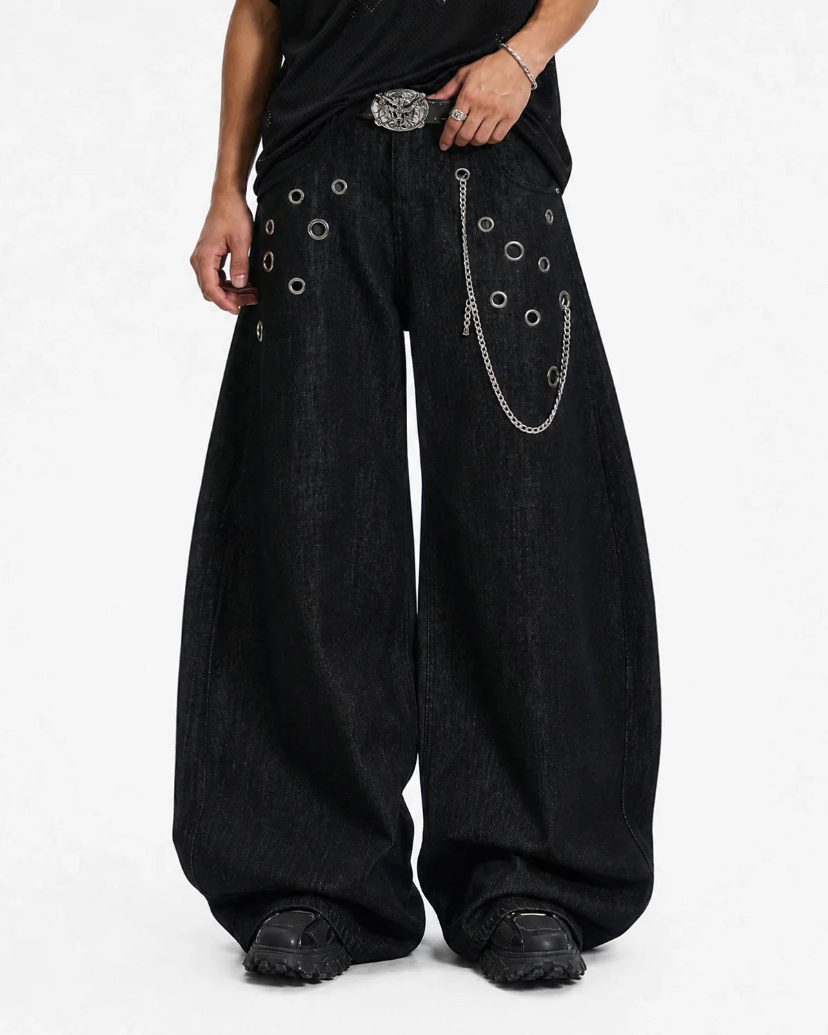 Metal eyelet chain barrel jeans by Flation Streetwear featuring distressed denim and chain details on a pair of stylish jeans.