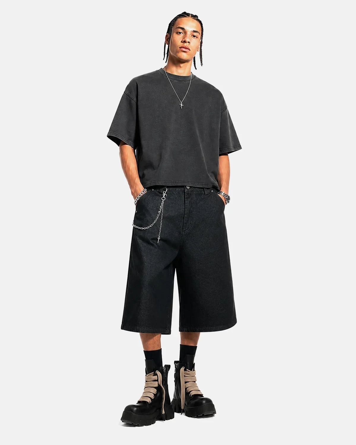 Black baggy long jorts by Flation Streetwear, featuring a loose fit and distressed denim design in a casual style.