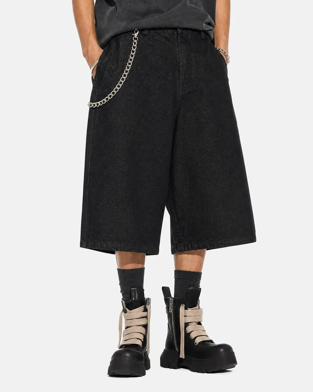 Black baggy long jorts by Flation streetwear, featuring loose fit denim shorts with a relaxed, oversized style.