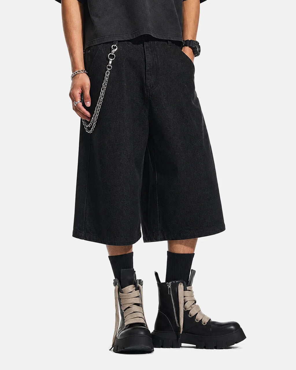 Black baggy long jorts by Flation Streetwear, casual denim shorts with a relaxed fit and distressed details.