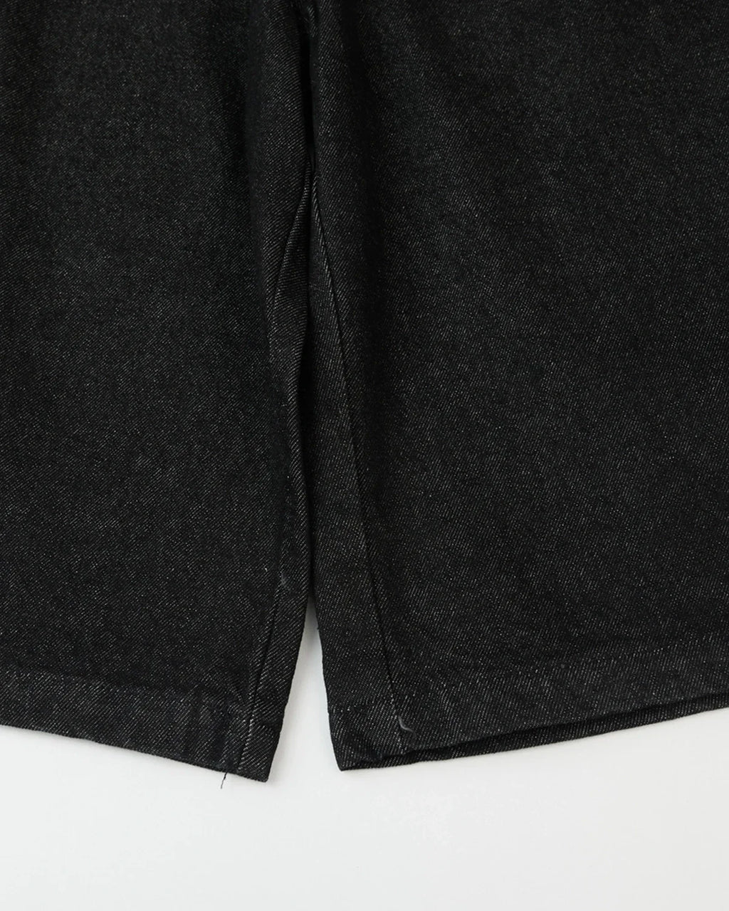 Black baggy long jorts from Flation Streetwear, casual denim shorts with a relaxed fit and distressed details