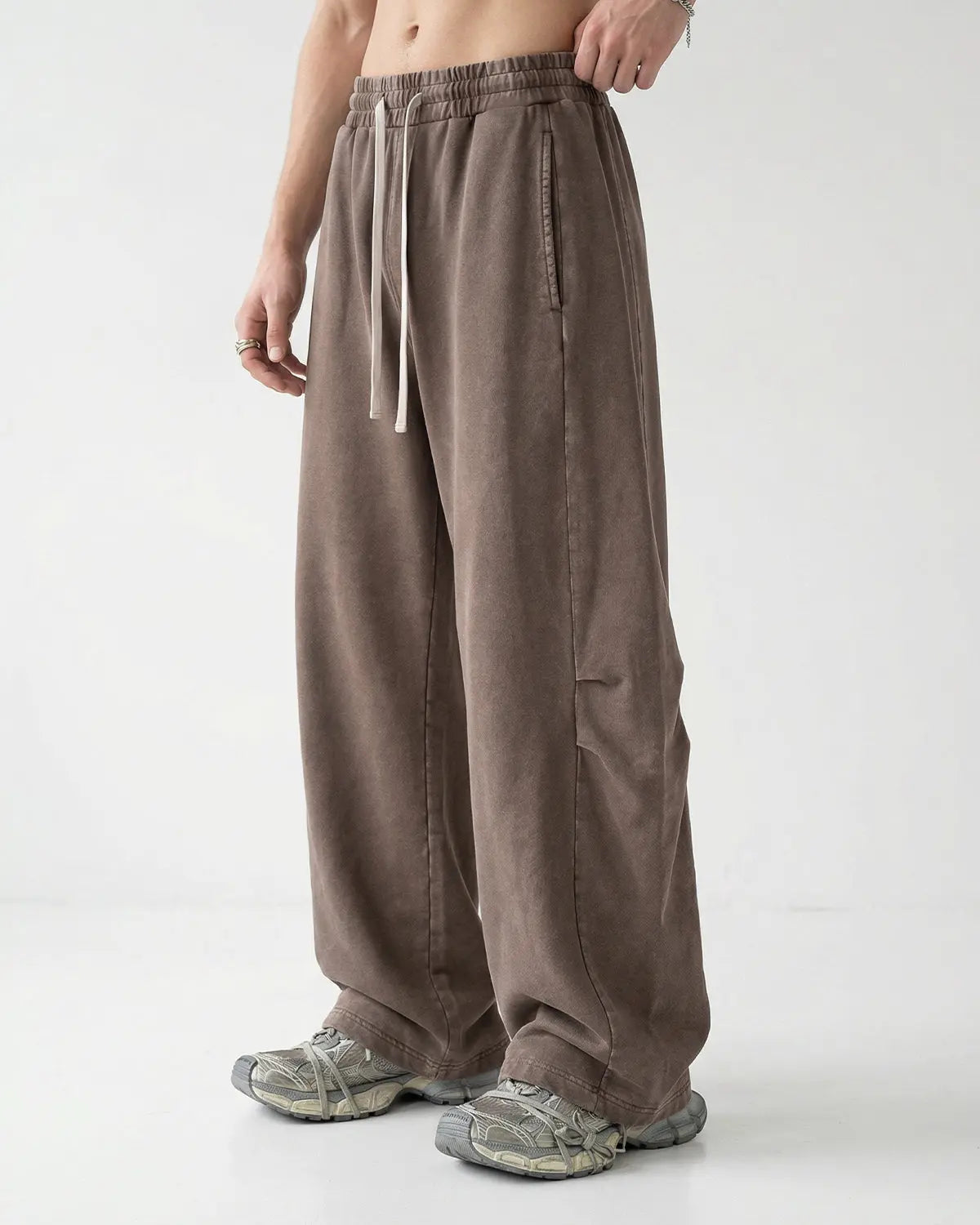 Khaki distressed acid-washed barrel sweatpants by Flation Streetwear, relaxed fit with a worn, vintage look.