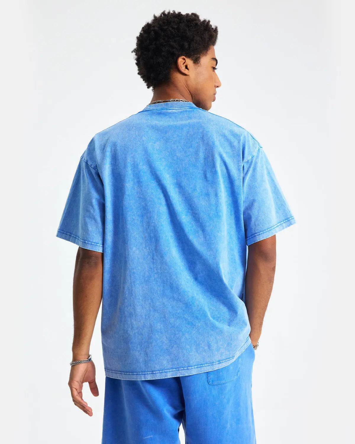 Light blue snow-washed oversized T-shirt by Flation Streetwear, relaxed fit with soft, textured fabric and casual style.