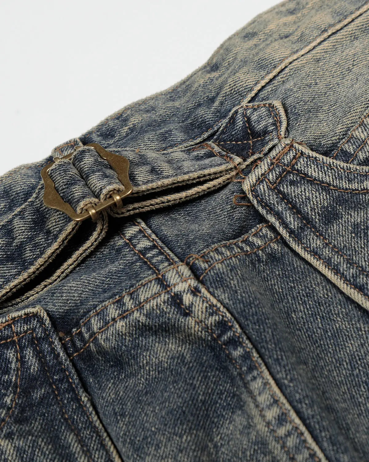 Acid washed Cinch Back Buckle Jorts by Flation Streetwear featuring a casual, distressed denim style with a buckle detail at the back.