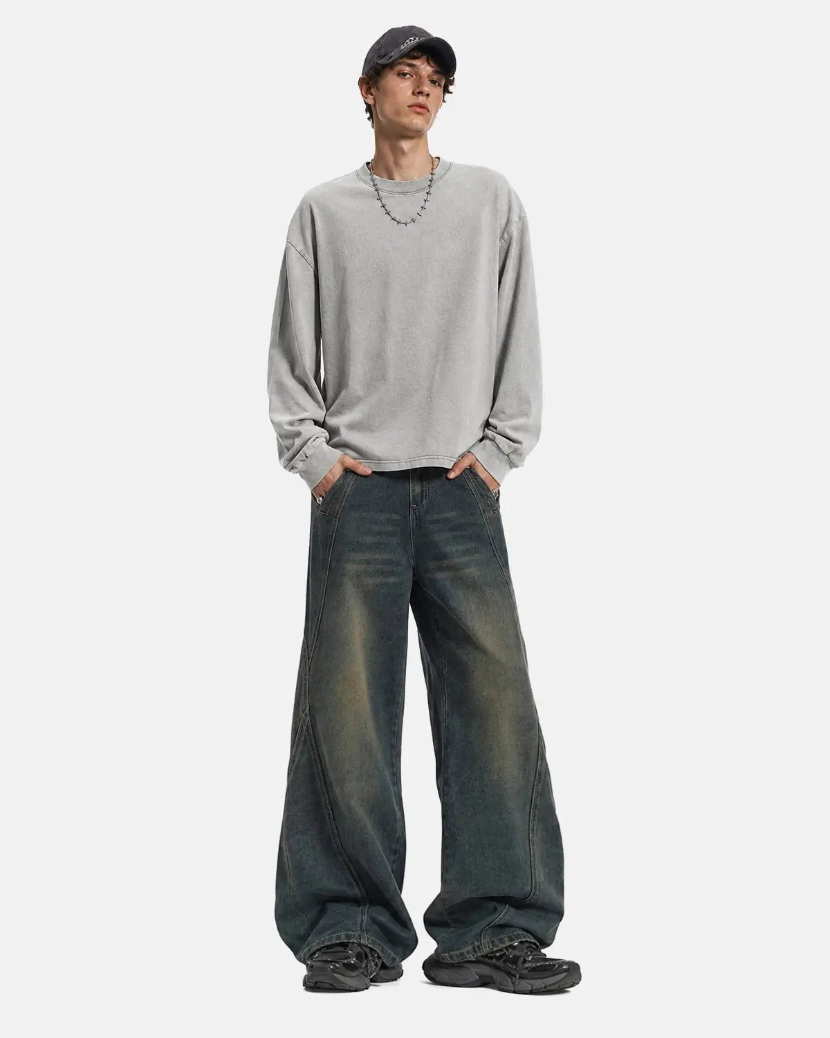 Deconstructed straight-leg jeans by INFLATION, showing distressed denim pants with frayed edges and unique cut-out details.