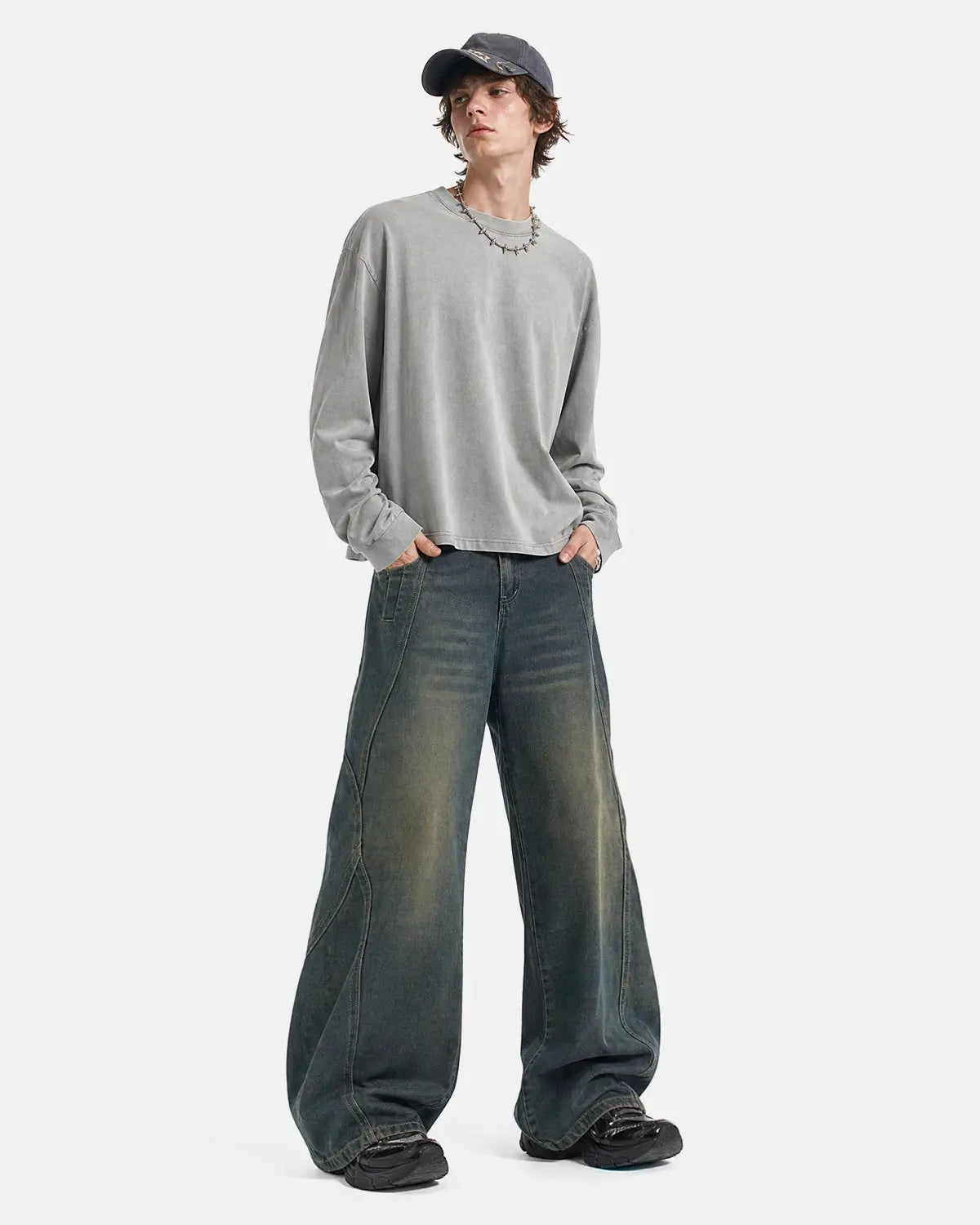 Deconstructed straight-leg jeans by INFLATION Streetwear, showing distressed denim with frayed hems and relaxed fit.