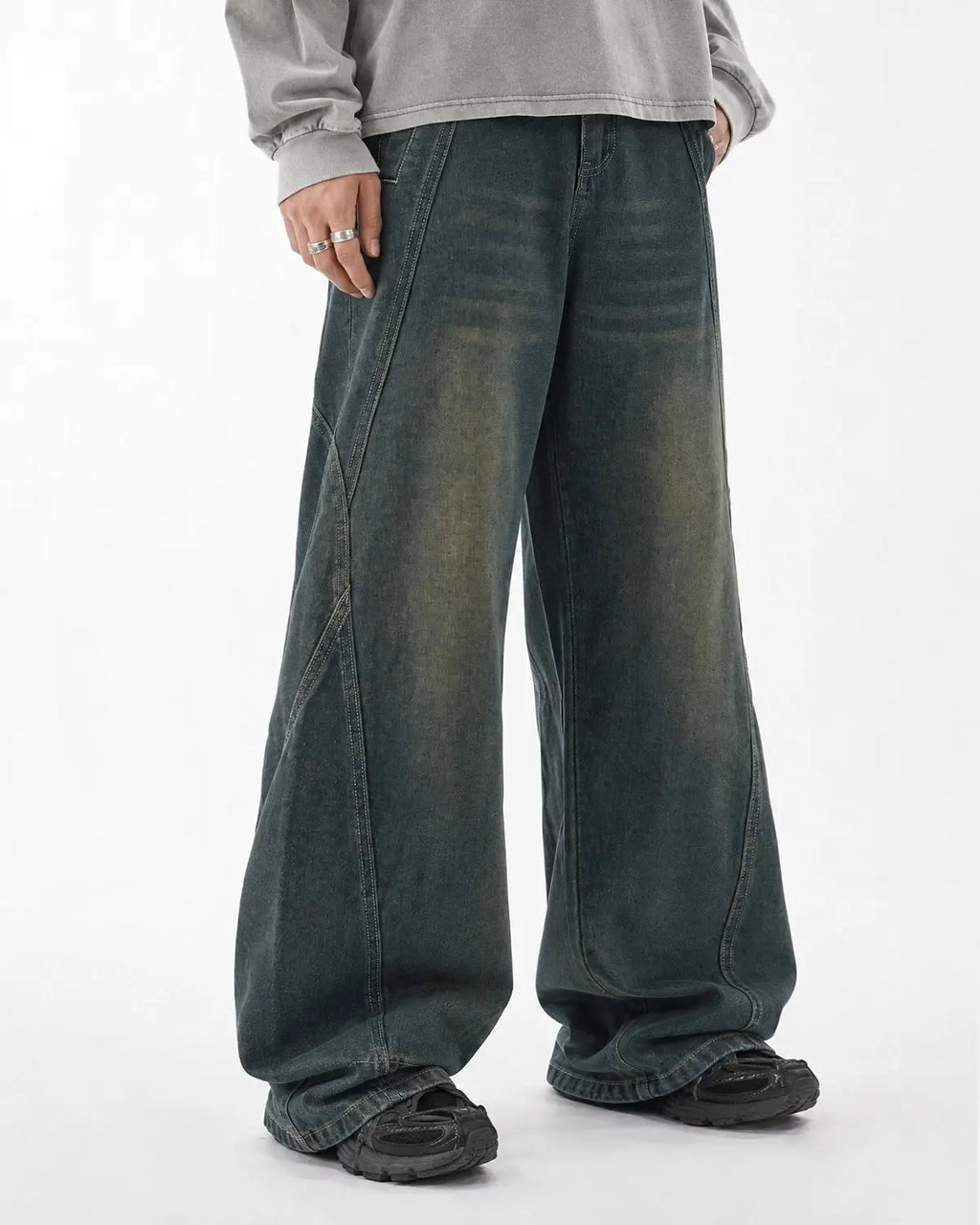 Deconstructed straight-leg jeans by INFLATION Streetwear, showing distressed details and casual fit on a pair of pants.