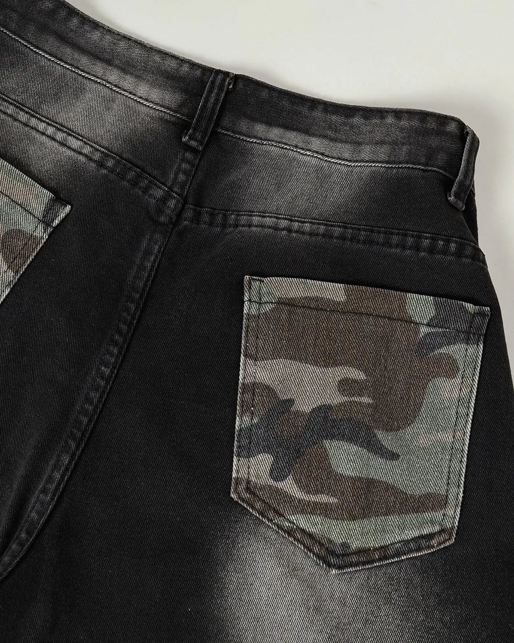 Flation Spray Graphic Camo Barrel Jeans featuring bold camo pattern and relaxed fit, streetwear style, shown on model.
