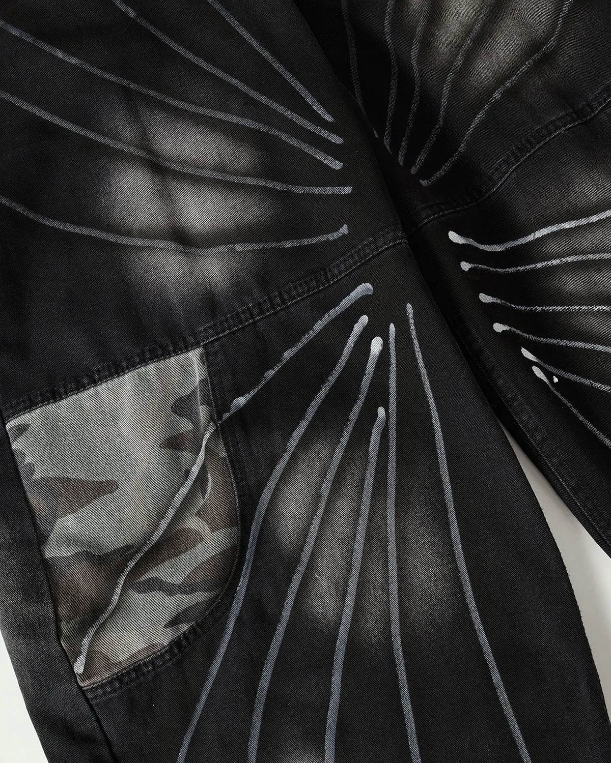 Flation Spray Graphic Camo Barrel Jeans, streetwear pants with spray pattern and relaxed fit, shown from the front.