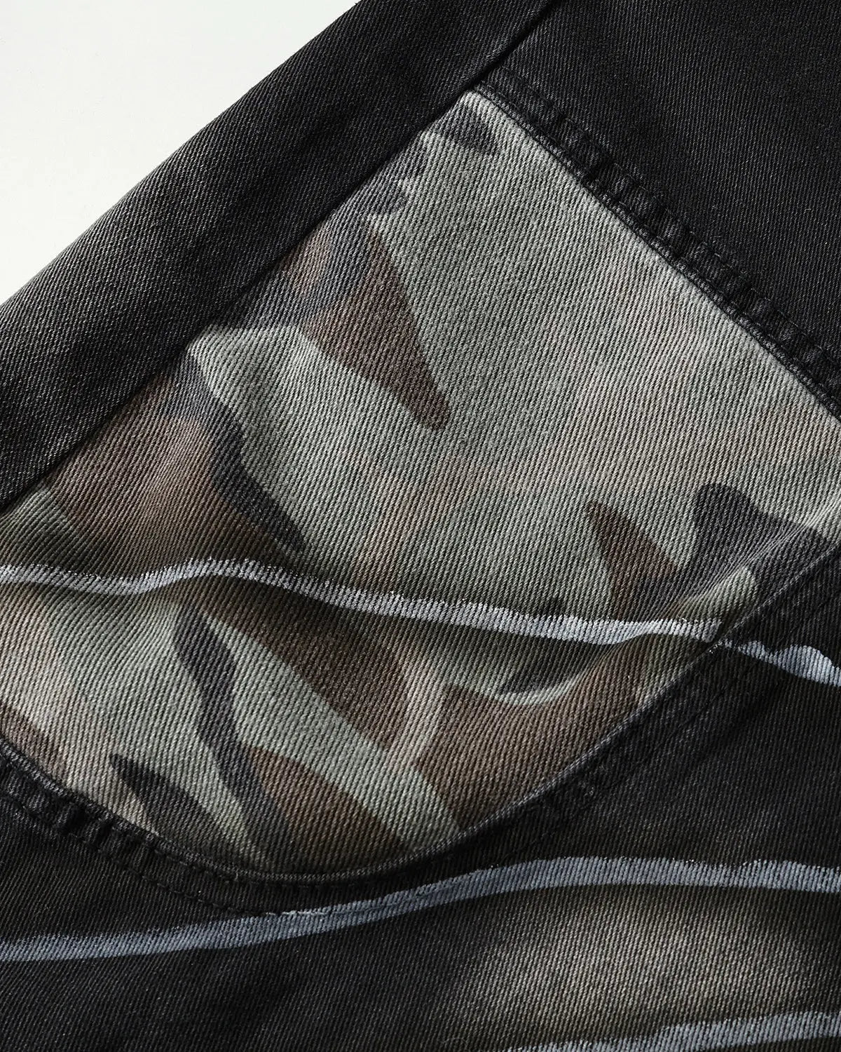 Flation Spray Graphic Camo Barrel Jeans, stylish streetwear pants with spray pattern and relaxed fit, shown in the image.