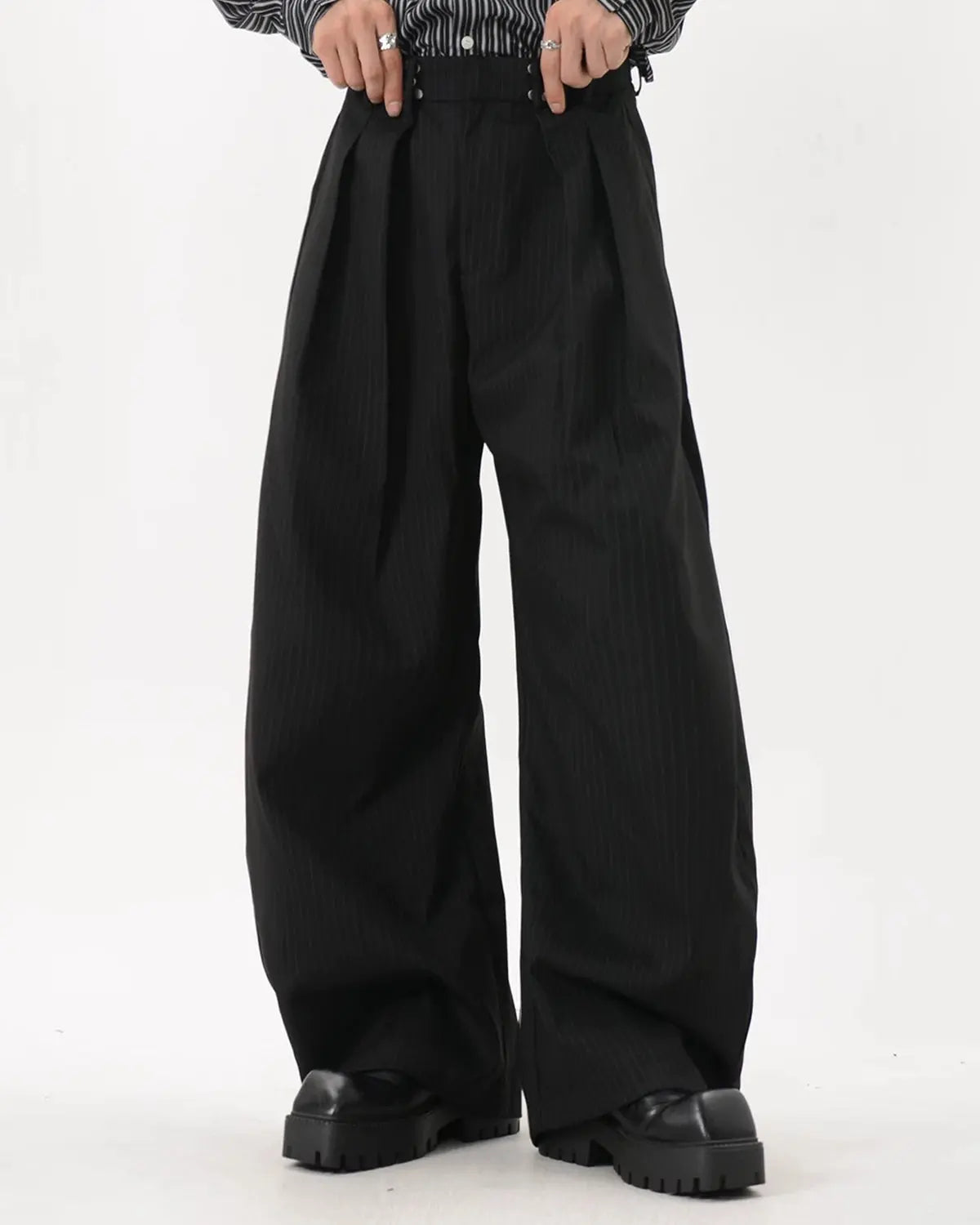 Black striped barrel suit pants by Flation streetwear, featuring a relaxed fit and stylish barrel silhouette.