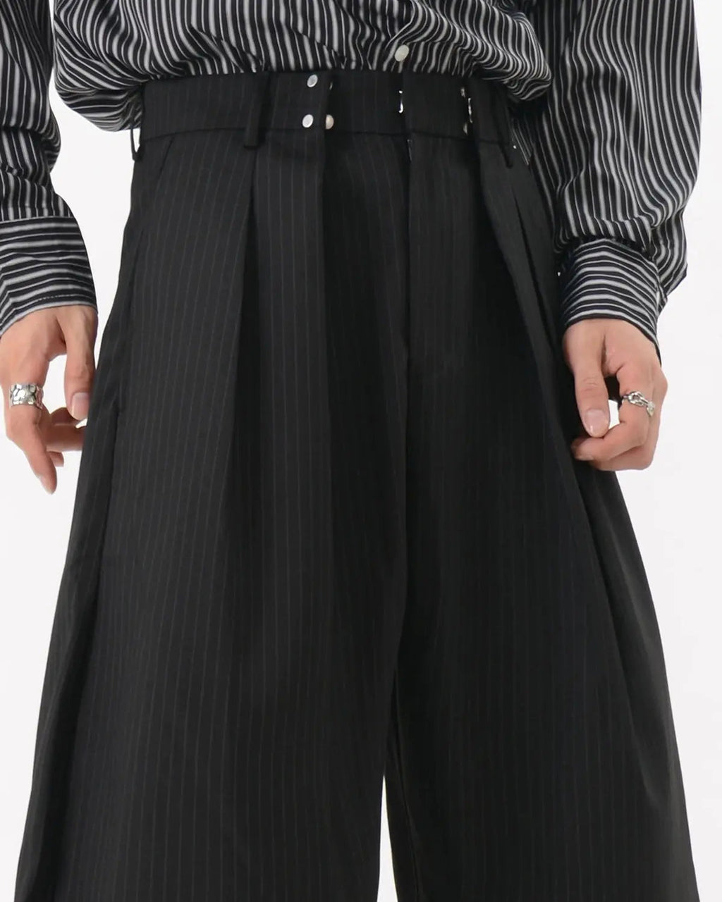 Black striped barrel pants by Flation Streetwear, relaxed fit with bold stripe pattern, casual streetwear style.